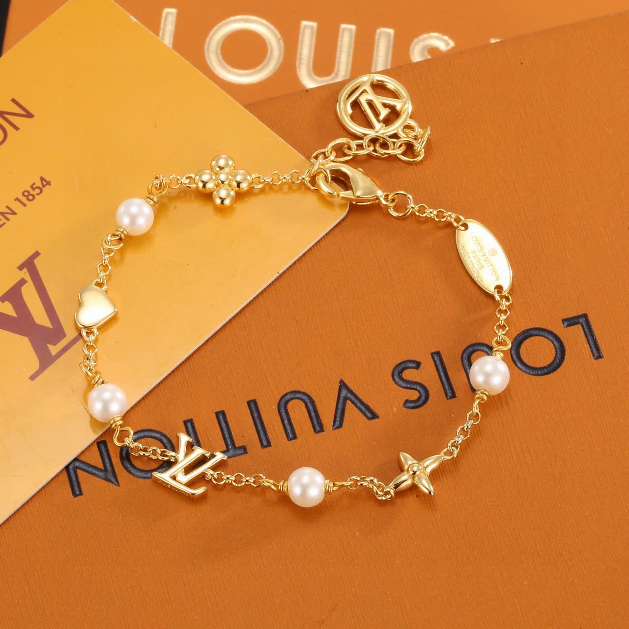 Louis Vuitton Gold Tone Bracelet with Pearls and Charms
